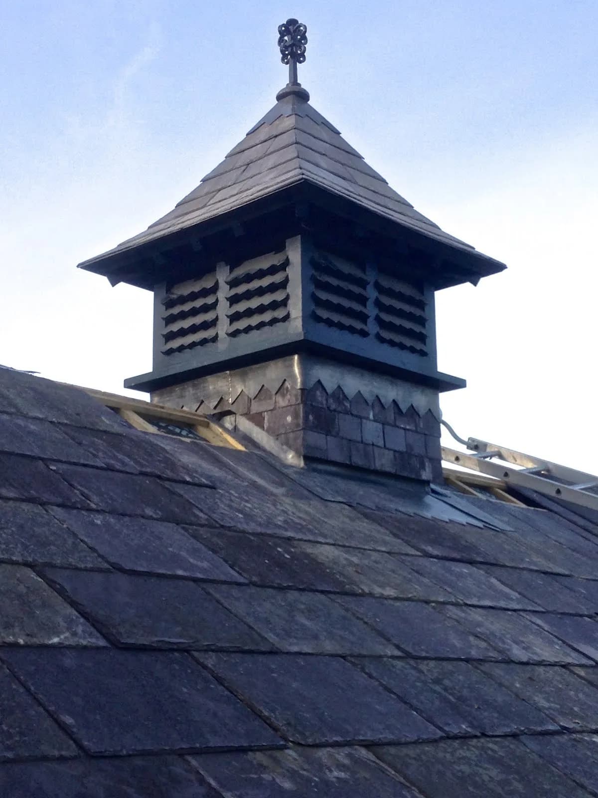 Restored decorative slate roof turret with new slate tiles and lead detailing