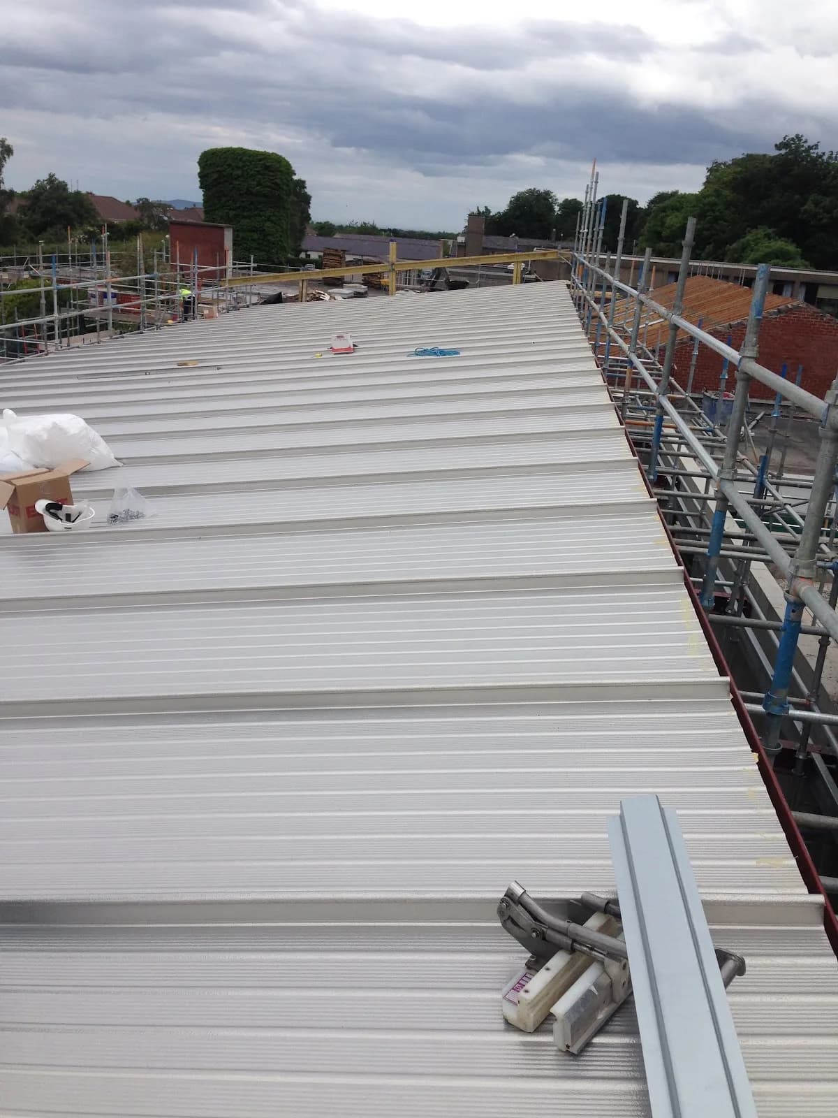 New metal roof being installed on a large building